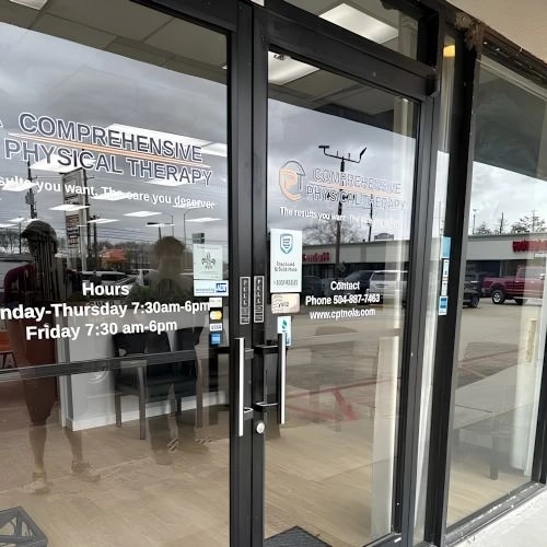 Entrance to Comprehensive Physical Therapy clinic with business hours and contact information on the glass doors