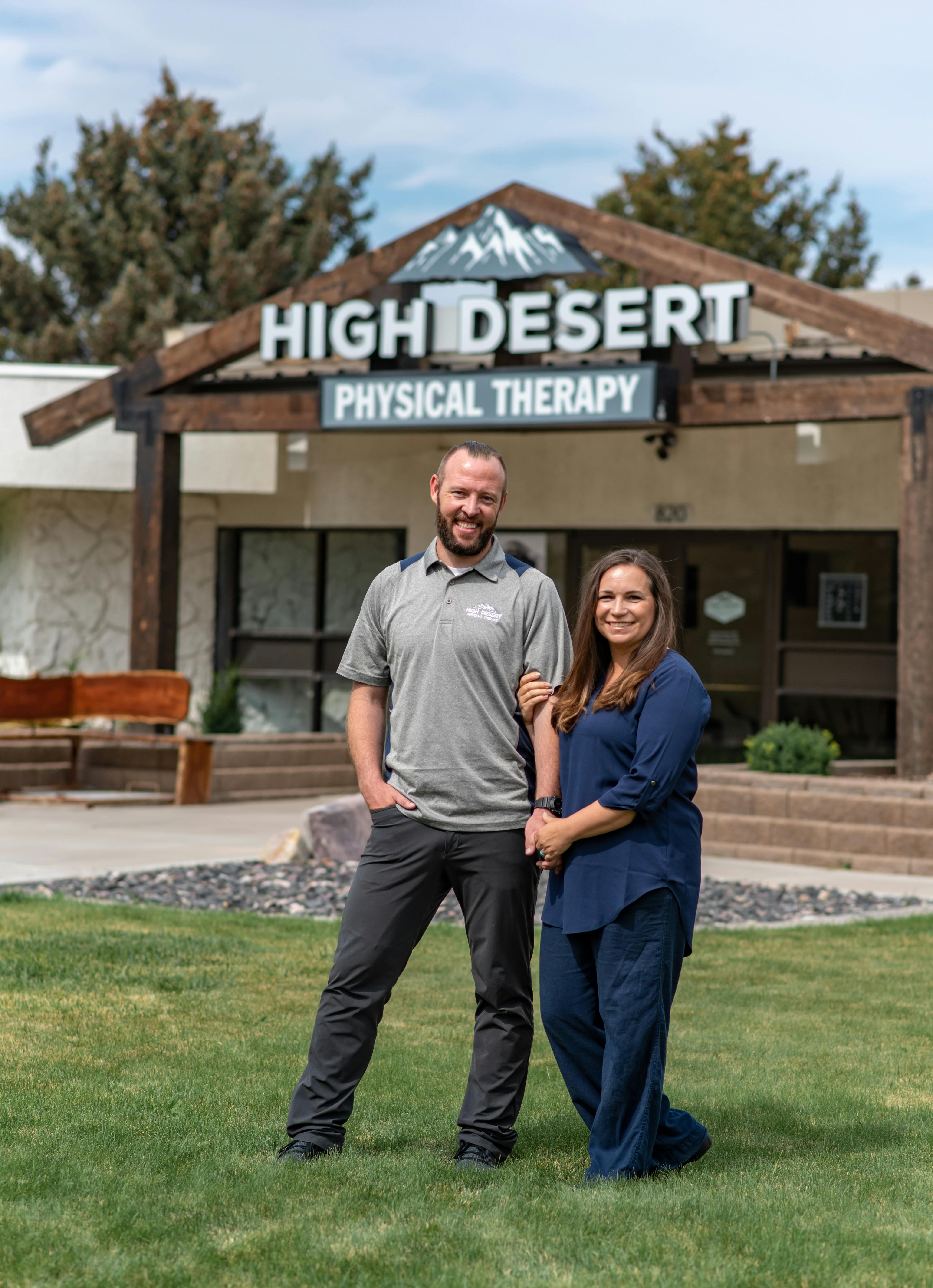 Jared and Emily Pugmire, the owners, standing in front of the clinic entrance