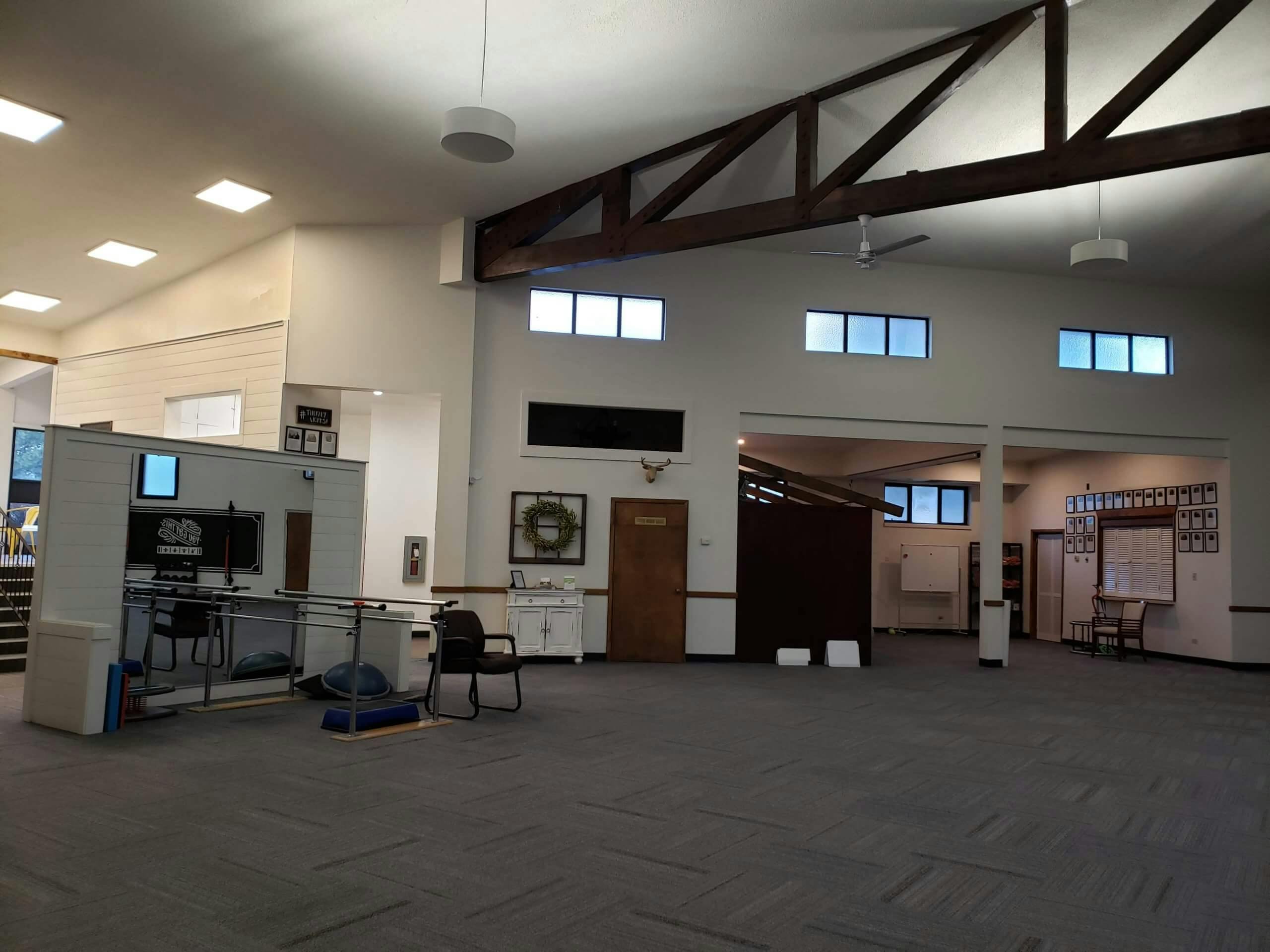 Open treatment floor inside the clinic with a high timber ceiling