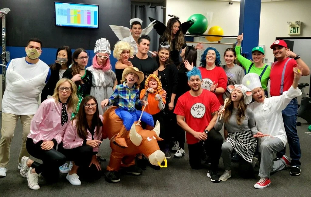 The LOR team posing together in costumes in the clinic