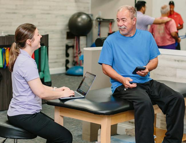 A physical therapist explaining an exercise to a patient