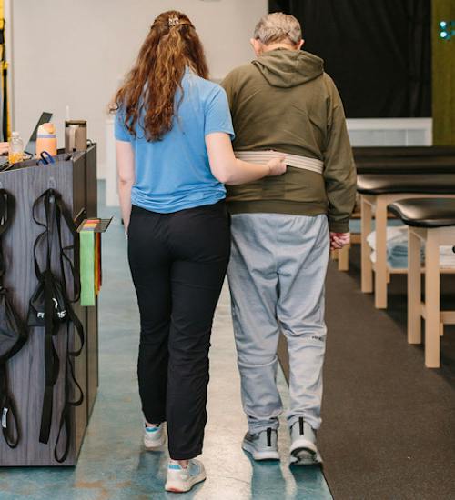 A physical therapist helping a patient with balance training
