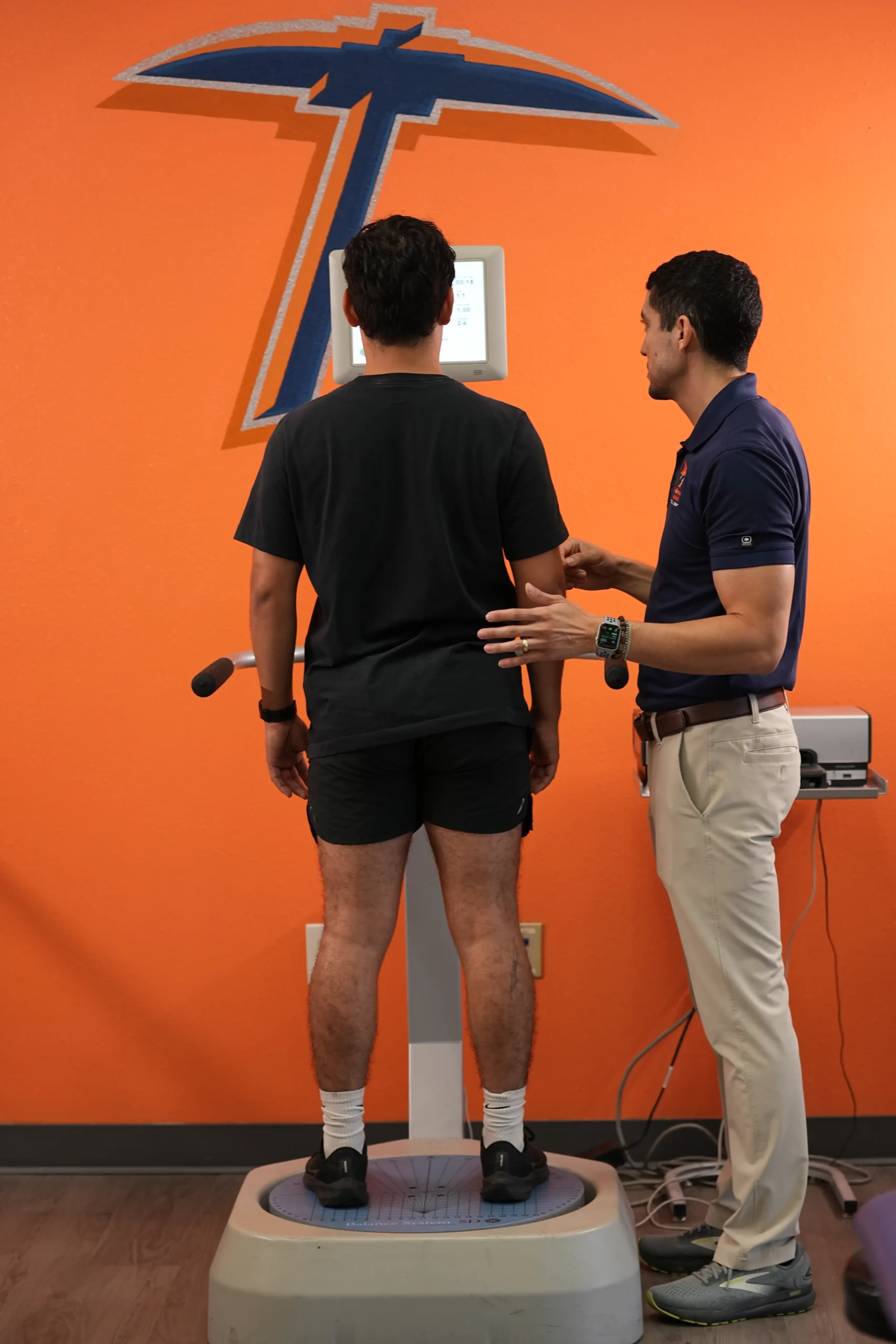A patient standing on a balance platform during a balance training session