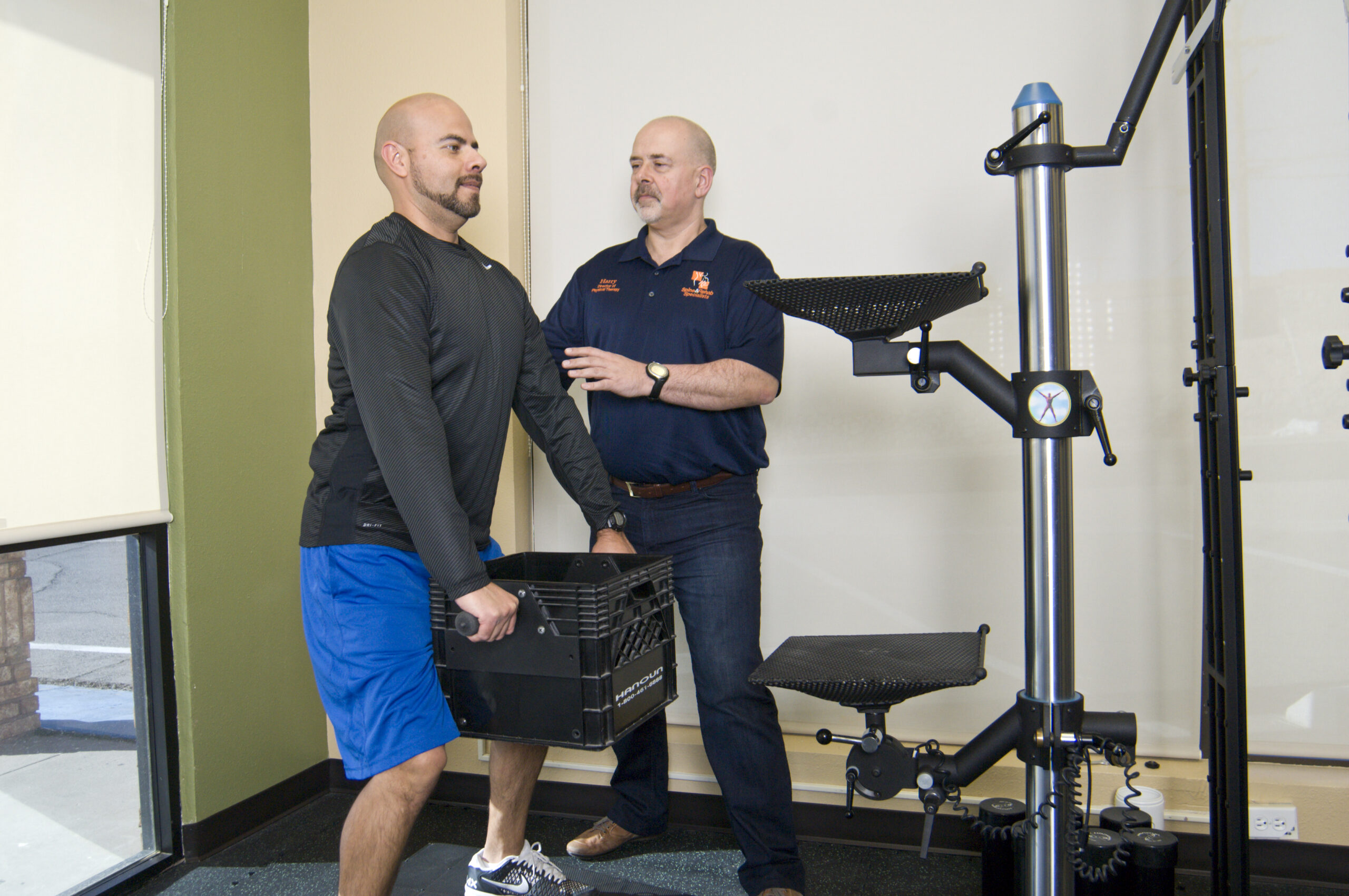 A worker lifting a crate during a lifting assessment
