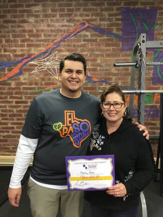 A patient and a therapist standing together in the clinic gym